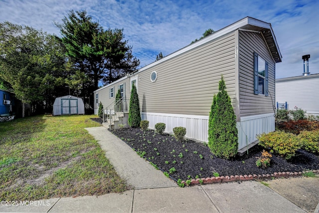 view of side of home featuring a shed and a lawn