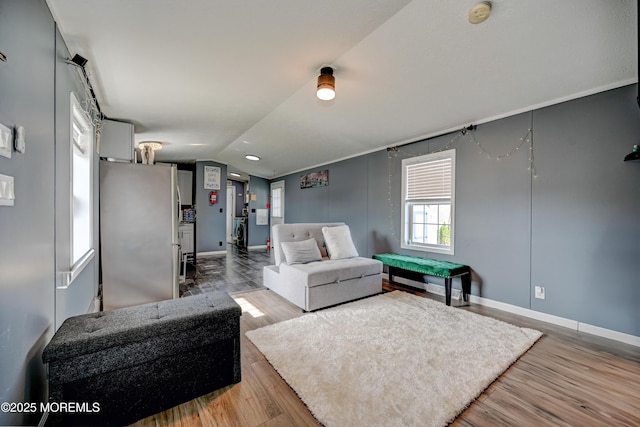 living room featuring light hardwood / wood-style flooring and vaulted ceiling