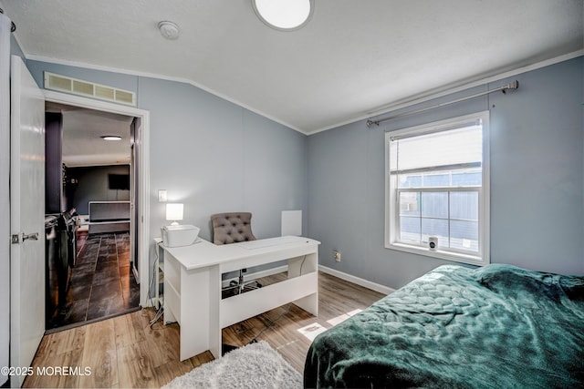 bedroom featuring hardwood / wood-style floors, crown molding, and vaulted ceiling