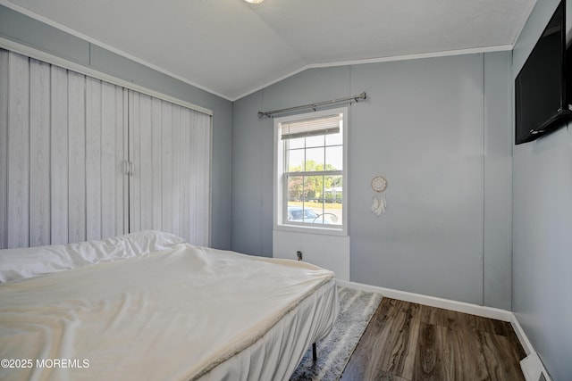 bedroom featuring ornamental molding, hardwood / wood-style flooring, and lofted ceiling