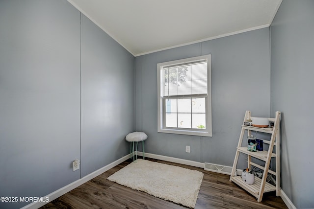 spare room featuring dark hardwood / wood-style floors, ornamental molding, and vaulted ceiling