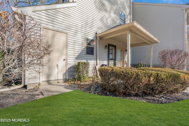 view of exterior entry with a lawn