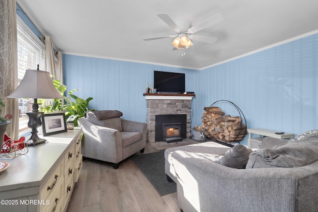 living room with ceiling fan, light wood-type flooring, and ornamental molding