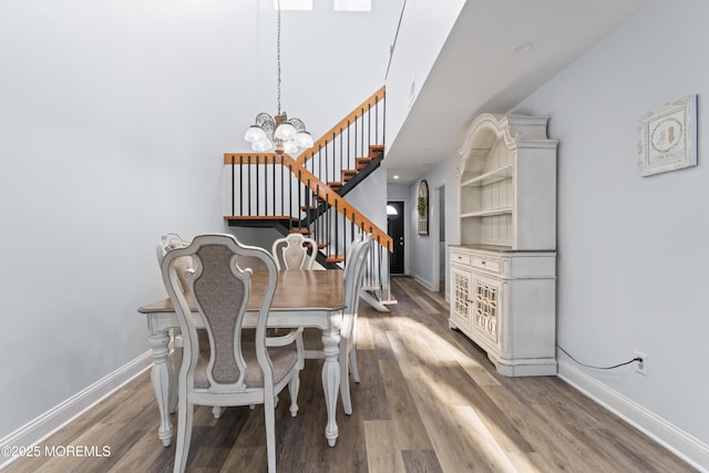 dining area featuring hardwood / wood-style floors and a chandelier