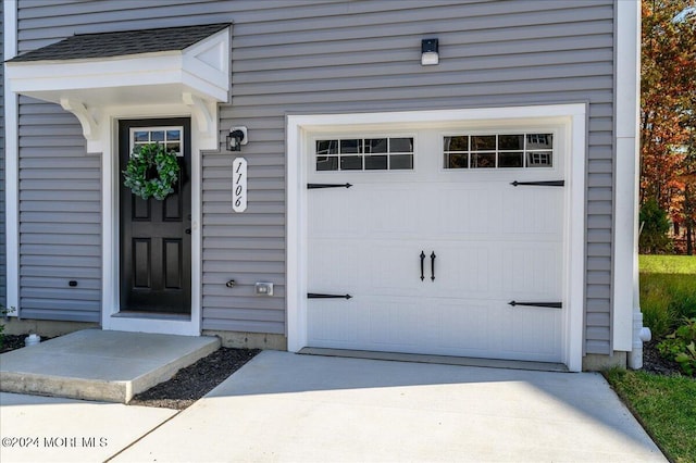 view of exterior entry with a garage