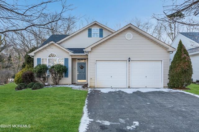 view of front of home featuring a garage and a front lawn