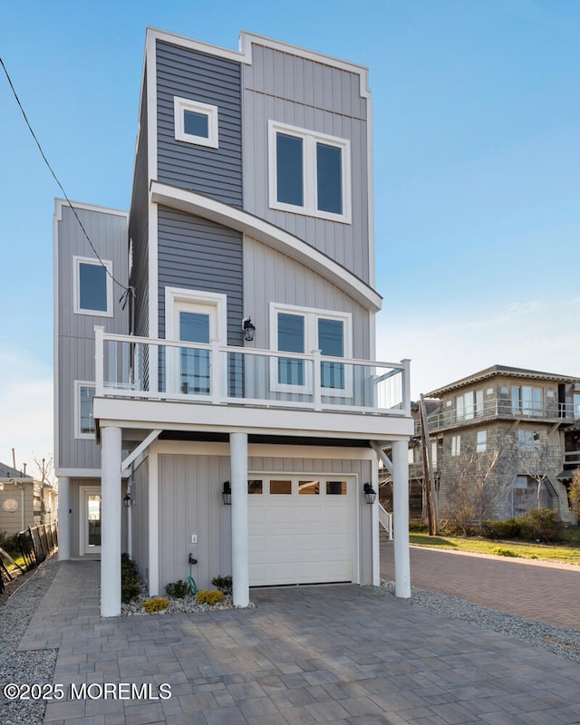 view of front facade with a garage and a balcony