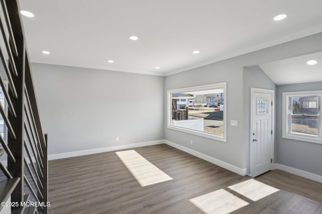 foyer featuring ornamental molding and dark hardwood / wood-style flooring