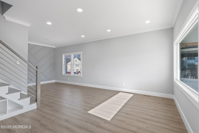 unfurnished living room featuring ornamental molding and light hardwood / wood-style floors