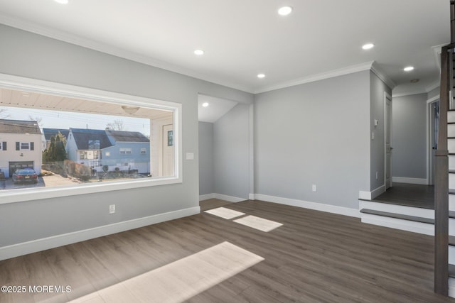 spare room featuring crown molding and dark hardwood / wood-style floors