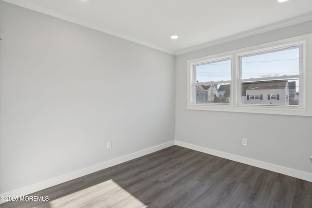 empty room with dark hardwood / wood-style flooring and crown molding