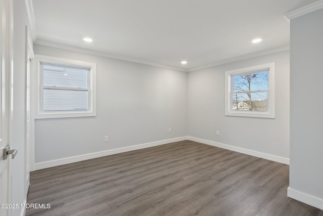 empty room featuring crown molding and dark hardwood / wood-style floors