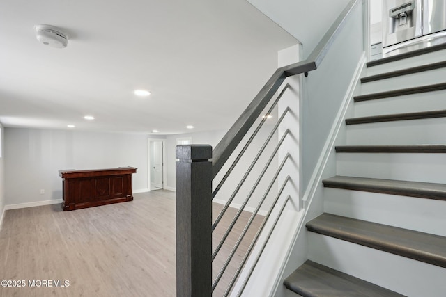 staircase with hardwood / wood-style flooring