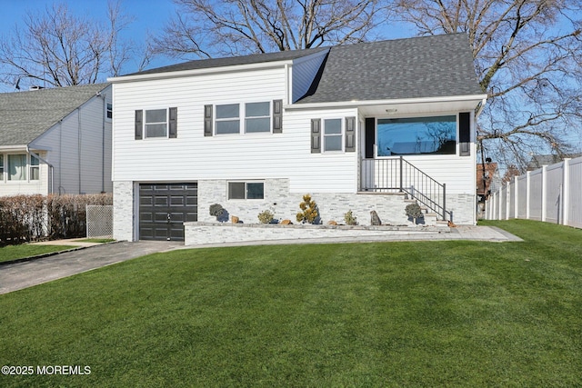 view of front of home with a front yard and a garage