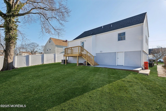 back of house with a patio area, central AC, a deck, and a yard