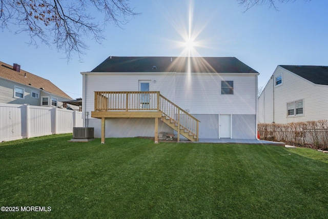 back of property featuring a yard and a deck