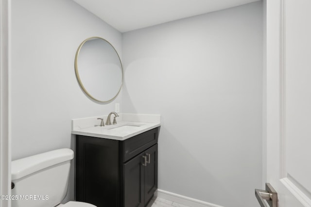 bathroom featuring toilet and vanity