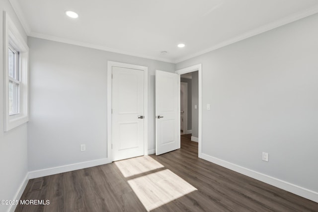 unfurnished bedroom featuring crown molding and dark hardwood / wood-style floors