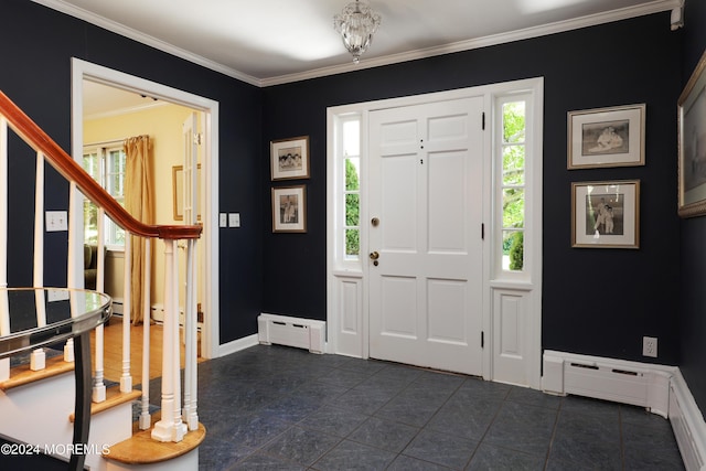 entryway with ornamental molding and a baseboard heating unit