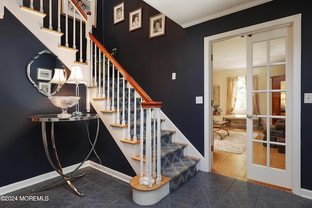 stairs featuring french doors, tile patterned flooring, and ornamental molding