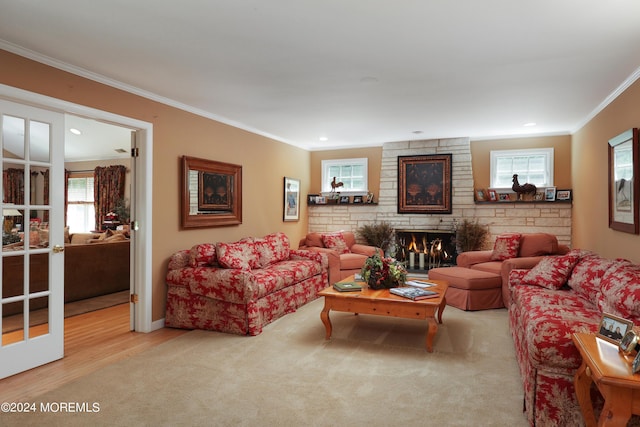 living room featuring light colored carpet, ornamental molding, and a fireplace