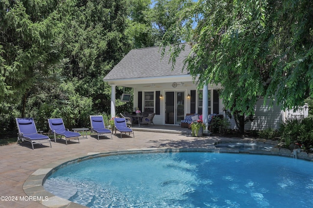 view of swimming pool with an outbuilding and a patio