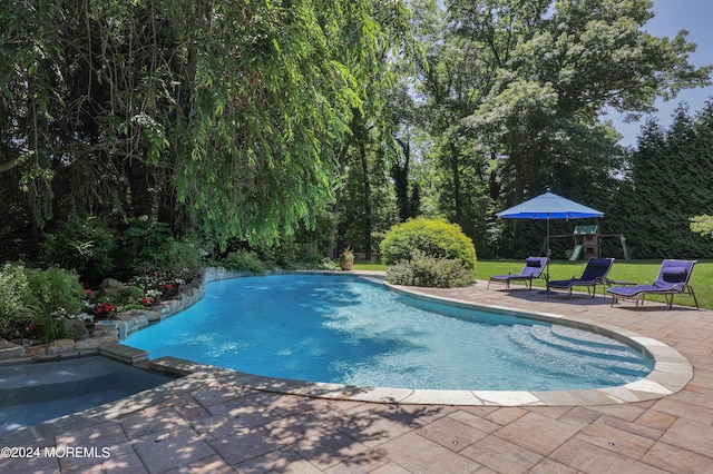 view of swimming pool featuring a yard and a patio