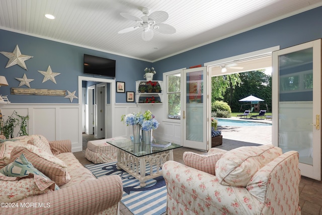 living room with ceiling fan and ornamental molding