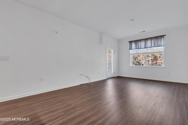 spare room with dark wood-type flooring