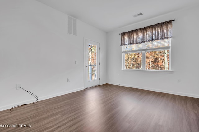 unfurnished room featuring dark hardwood / wood-style floors