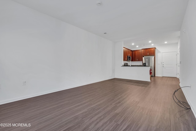 unfurnished living room with wood-type flooring