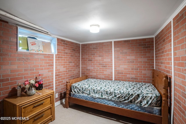 bedroom with ornamental molding and brick wall