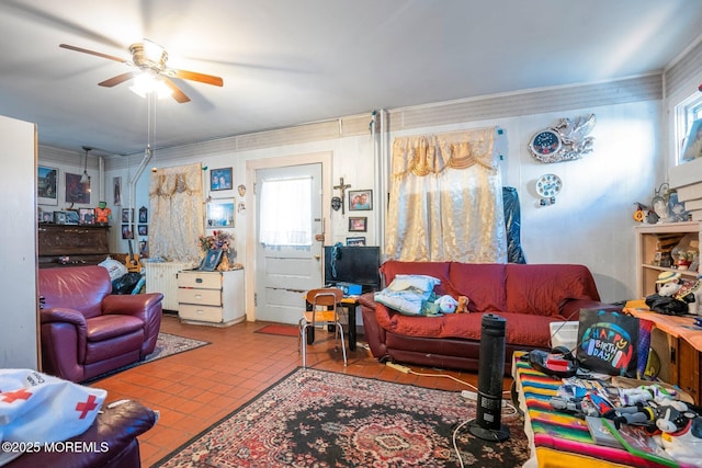 tiled living room with radiator, ceiling fan, and ornamental molding