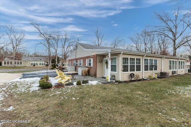 view of front of home featuring a patio and a lawn