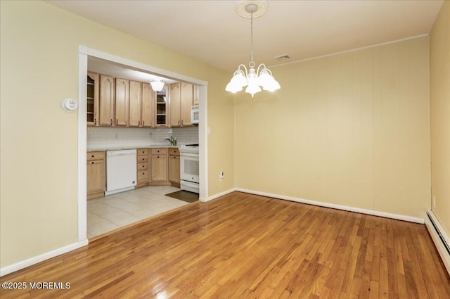 kitchen with a baseboard radiator, an inviting chandelier, tasteful backsplash, white appliances, and light brown cabinetry