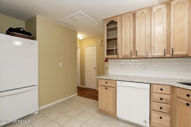 kitchen with decorative backsplash, light brown cabinetry, light stone counters, white appliances, and light tile patterned floors