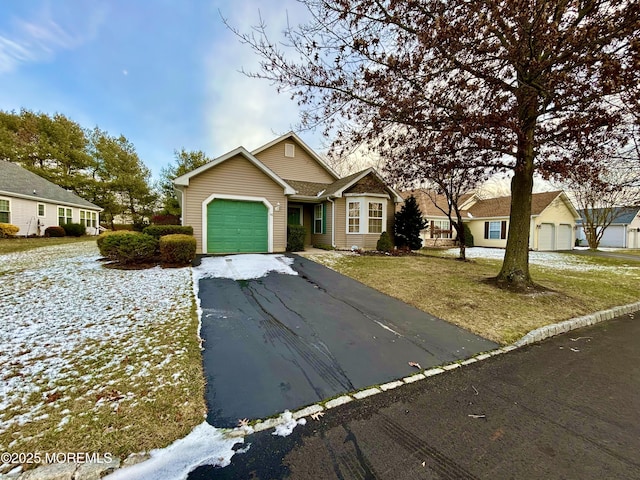 view of front facade with a garage and a front lawn