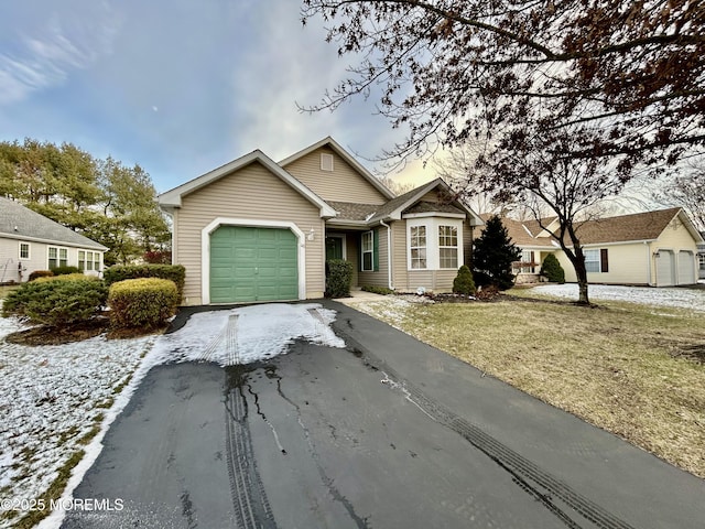 view of front of home with a front yard and a garage