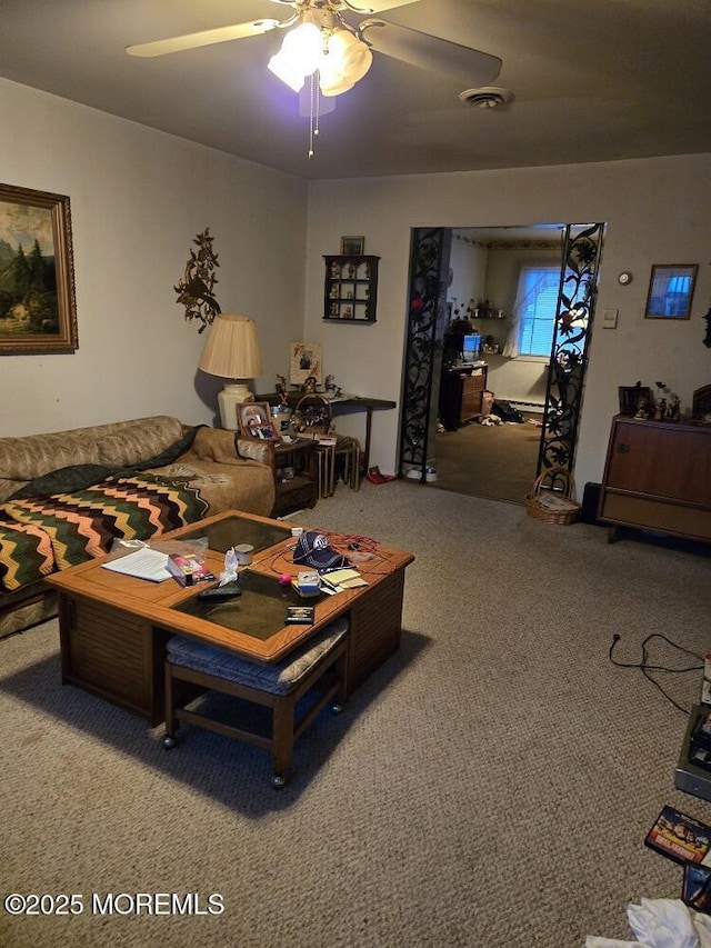 carpeted living room with ceiling fan