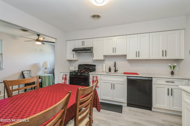 kitchen featuring black appliances, light hardwood / wood-style floors, white cabinetry, and sink