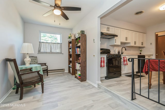 kitchen with white cabinetry, ceiling fan, black gas range oven, baseboard heating, and light hardwood / wood-style flooring