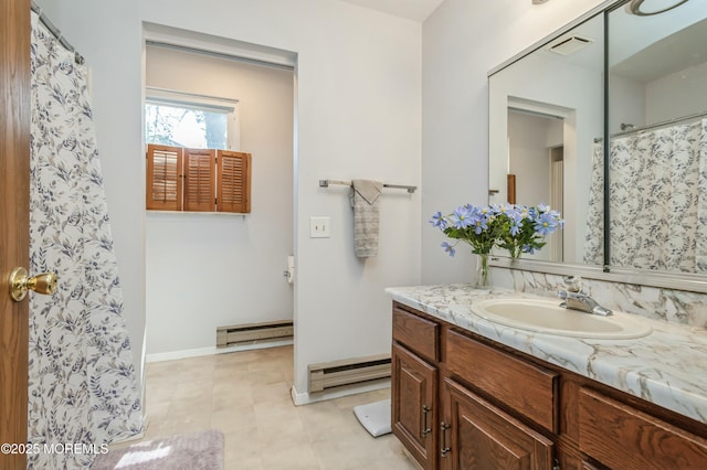 bathroom featuring vanity and a baseboard heating unit