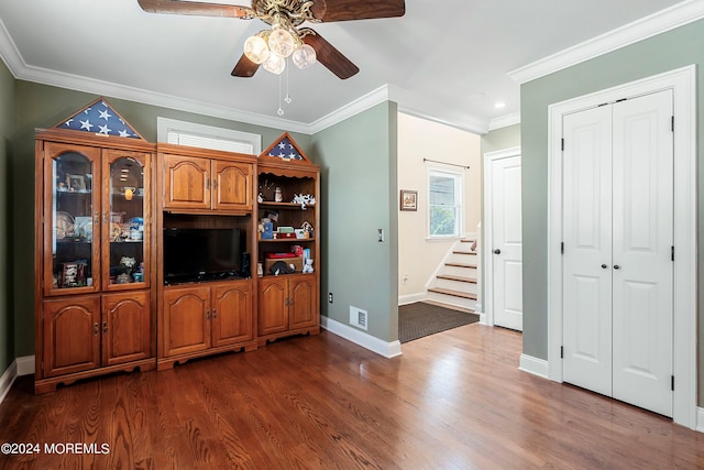 living room with ornamental molding, dark hardwood / wood-style floors, and ceiling fan