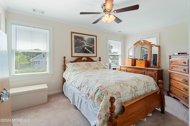 carpeted bedroom with crown molding, ceiling fan, and multiple windows