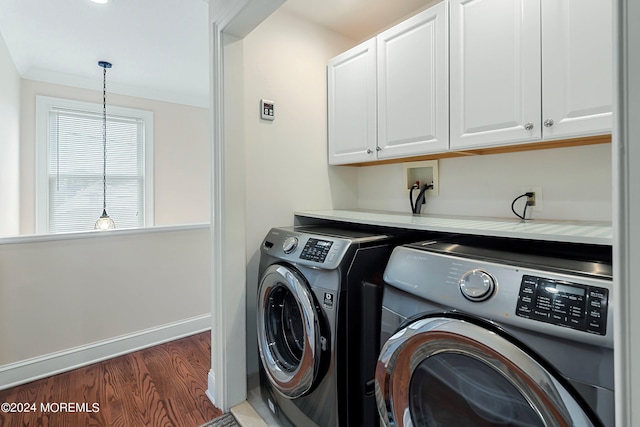 laundry room with dark hardwood / wood-style flooring, cabinets, crown molding, and independent washer and dryer