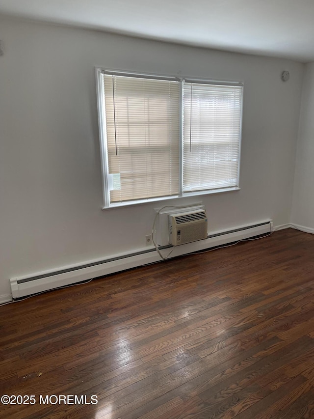 unfurnished room with dark hardwood / wood-style flooring and a baseboard radiator