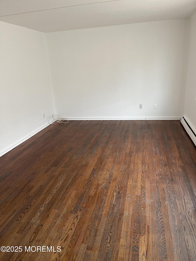 unfurnished room with dark wood-type flooring