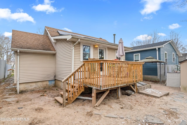 back of property with a wooden deck