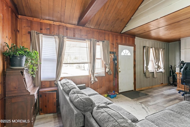 living room with light wood-type flooring, vaulted ceiling, and wood ceiling