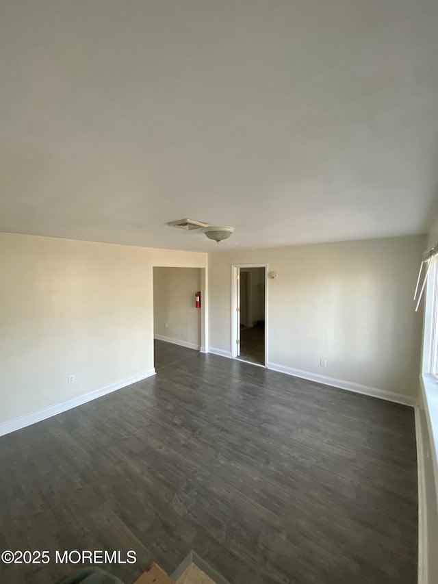 spare room featuring dark hardwood / wood-style flooring